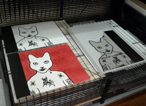 A lino block and prints on the drying rack